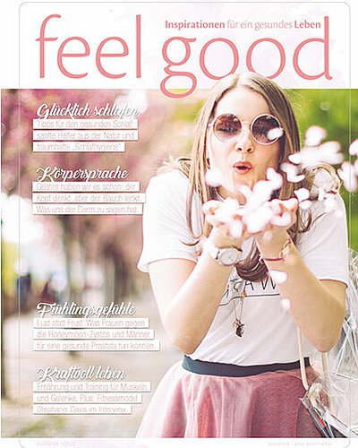Bild vom Cover des aktuellen feel good Magazins. Frau pustet Blumen aus ihrer Hand.
